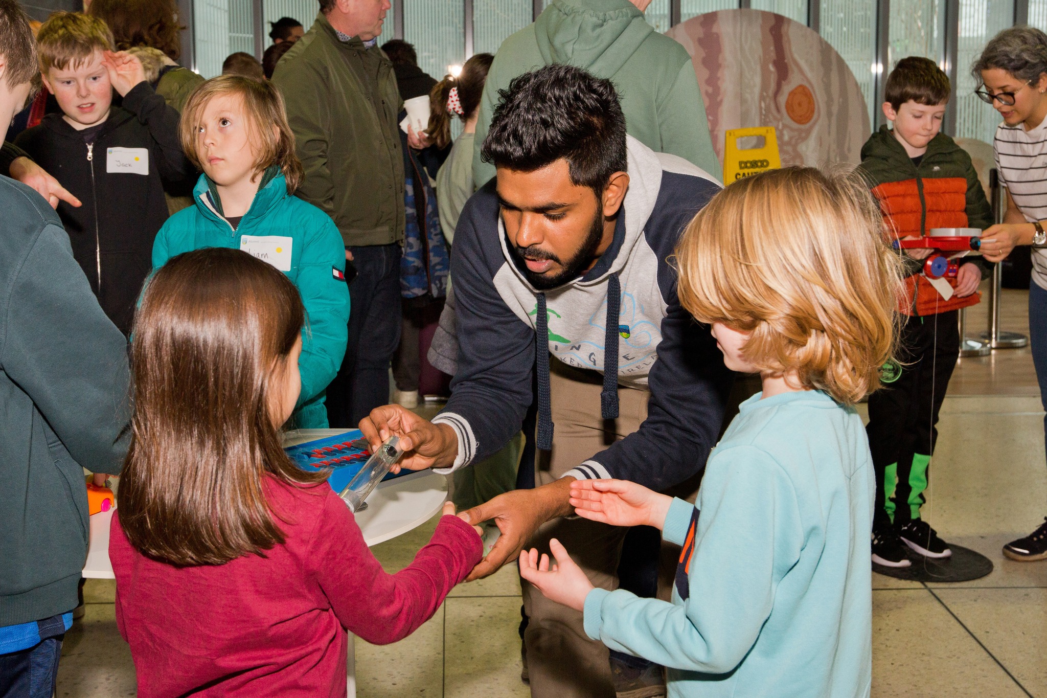 Scientist showcasing STEM experiments to children